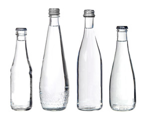 glass bottles with water isolated on white