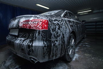 black car in foam on sink