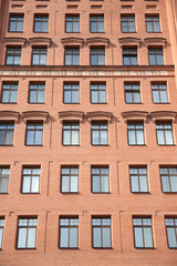 Fototapeta na wymiar Front view of brick wall contemporary apartment building