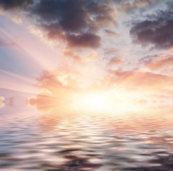 Beautiful sunset over sea with reflection in water