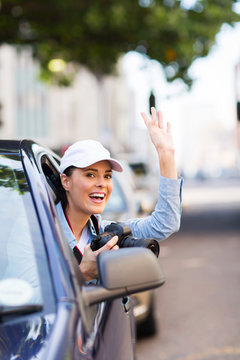 tourist waving inside a car