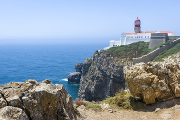 Fototapeta na wymiar Rocky coastline and lighthouse in Sagres, Portugal