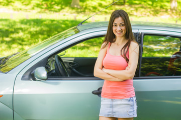 Young woman showing new car