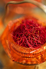 saffron spice in antique vintage glass bowl, closeup - 67063250
