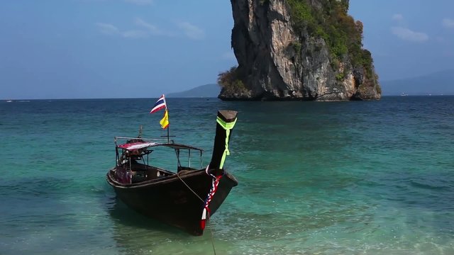 Classic boat near tropical islands with crystal clear water