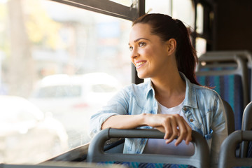 young woman taking bus to work - obrazy, fototapety, plakaty