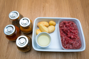 Raw ingredients minced meat potato close up