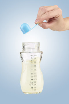 Mother prepares baby milk formula
