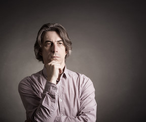 Portraits of men on a dark background.