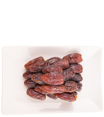 Date fruits on a white plate