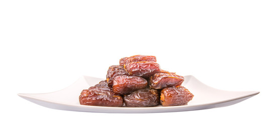 Date fruits on a white plate