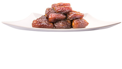 Date fruits on a white plate