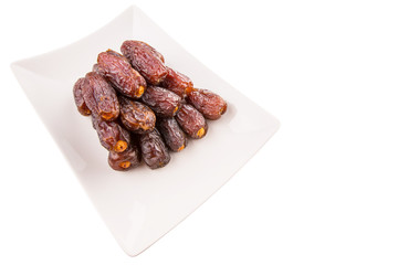 Date fruits on a white plate
