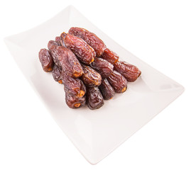 Date fruits on a white plate