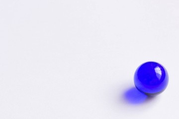 One blue glass marble - Lower right