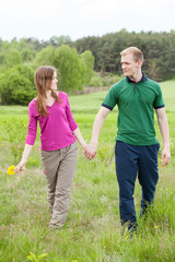 Couple in love walking on meadow