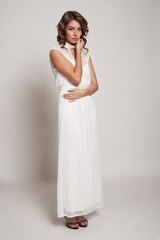 Fototapeta premium Model brunette with long curly hair. Studio photo