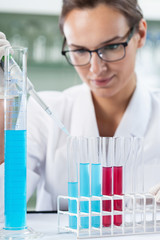 Scientist researcher using a pipette and test tubes