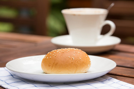 bread with sesame seeds and coffee