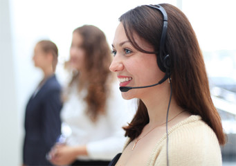 Young employee working with a headset and accompanied