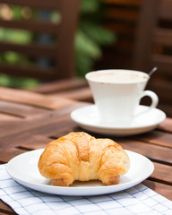 breakfast with croissants, cup of coffee