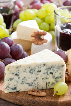 Assorted snacks and red wine, blue cheese and camembert