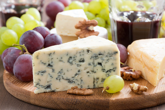 Assorted snacks and red wine, blue cheese, cheddar, camembert
