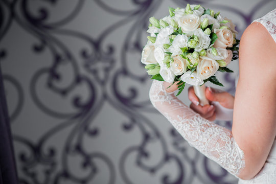 Beautiful wedding bouquet in hands of the bride