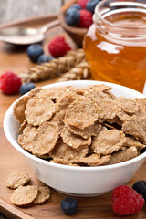 cereal flakes, milk and honey for breakfast, close-up