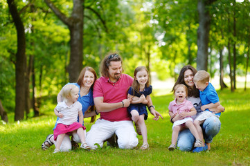 Naklejka na ściany i meble Happy big family having fun in summer park