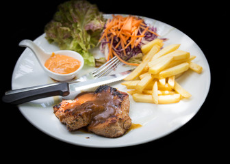 juicy grilled pork chop (neck cut) with greens