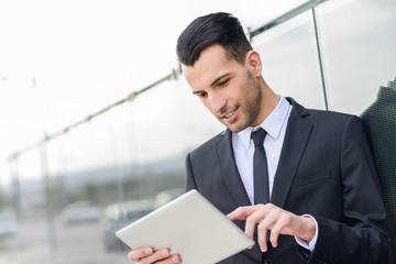 Businessman with tablet computer in office building