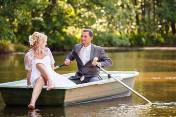 Young just married bride and groom on boat