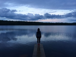 Girl standing on a pier