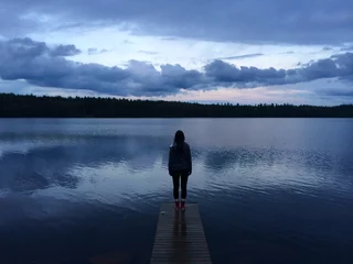 Fotobehang Pier Girl standing on a pier  © akslam