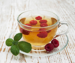 Cup of tea with raspberry