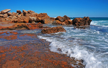 Fototapeta na wymiar Huge rocks on the coast of the storm sea