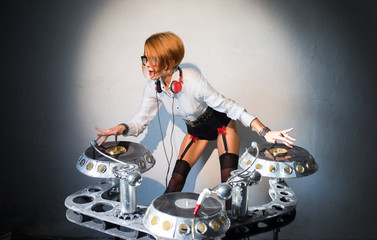 Girl DJ plays on wall background on the plates