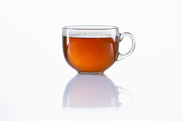 Glass cup of black tea on white background