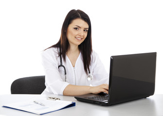 beautiful woman doctor working on a laptop and smiling