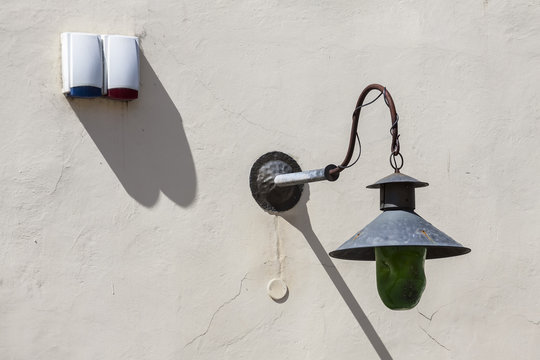 Old lantern on the wall of the building.