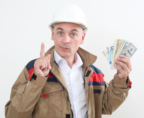 man in uniform with white construction helmet and holding money