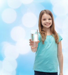 smiling little girl giving glass of water