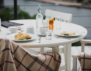 Fototapeta premium breakfast with cheesecakes, toast, cappuccino and macarons