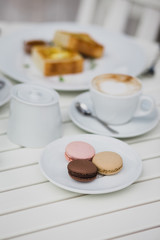 breakfast with cheesecakes, toast, cappuccino and macarons