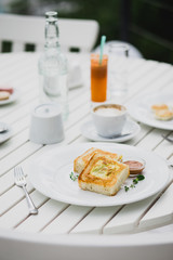 breakfast with cheesecakes, toast, cappuccino and juice