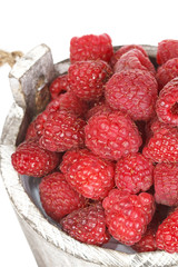 Fresh raspberry in the wooden bucket