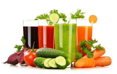Glasses with fresh vegetable juices isolated on white