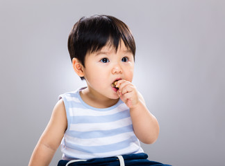Cute baby having cookie