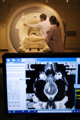 veterinarian doctor working in MRI  room with moniter foreground